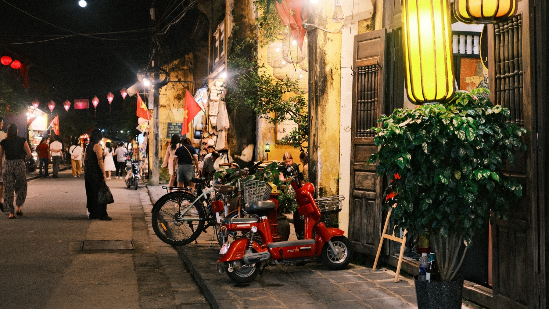 hoi an at night, lanterns and a red scooter