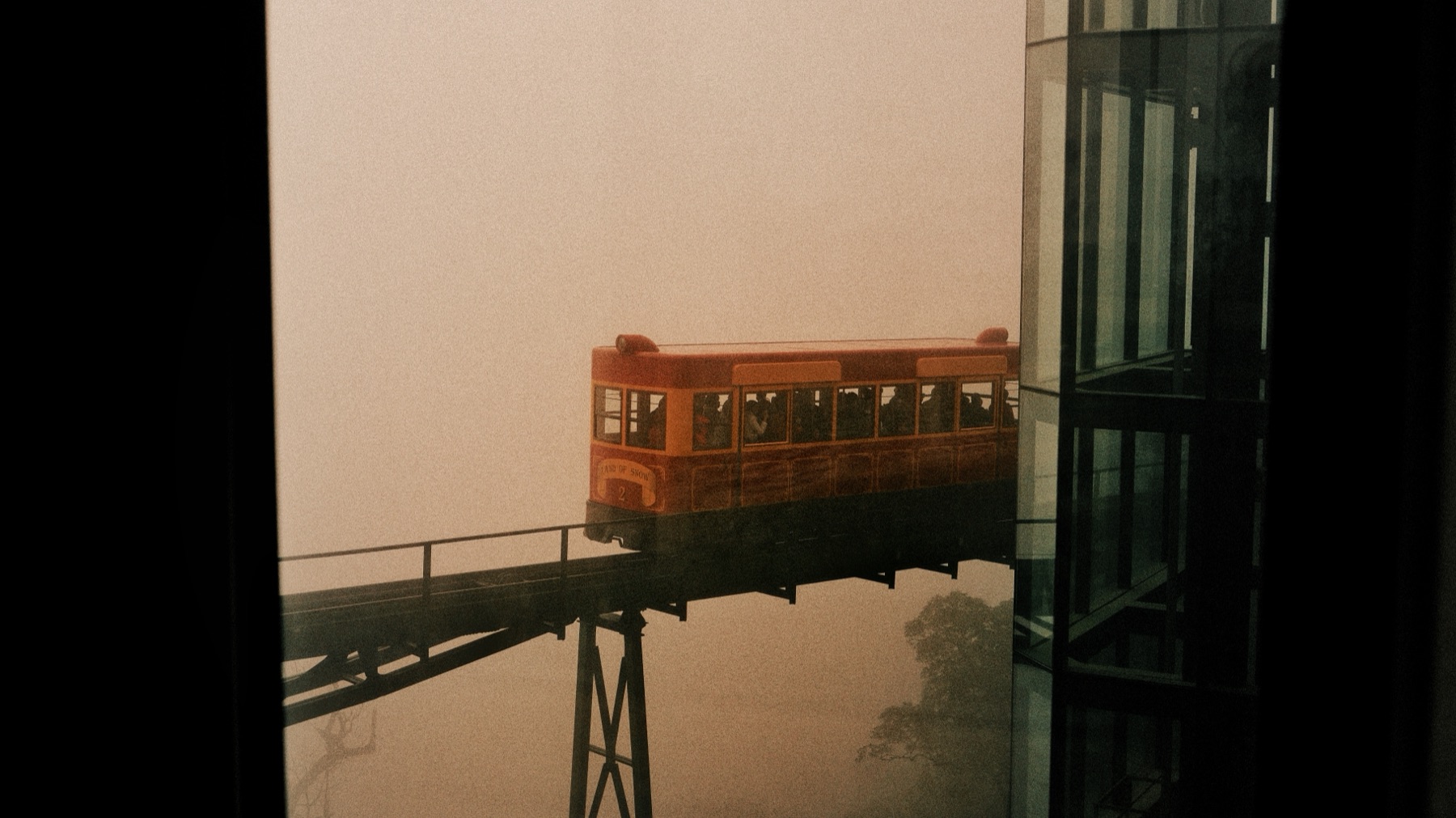 funicular tram disappearing into fog